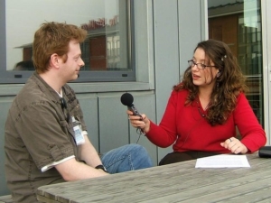 how to prepare for an interview, like this picture of a lady interviewing a man