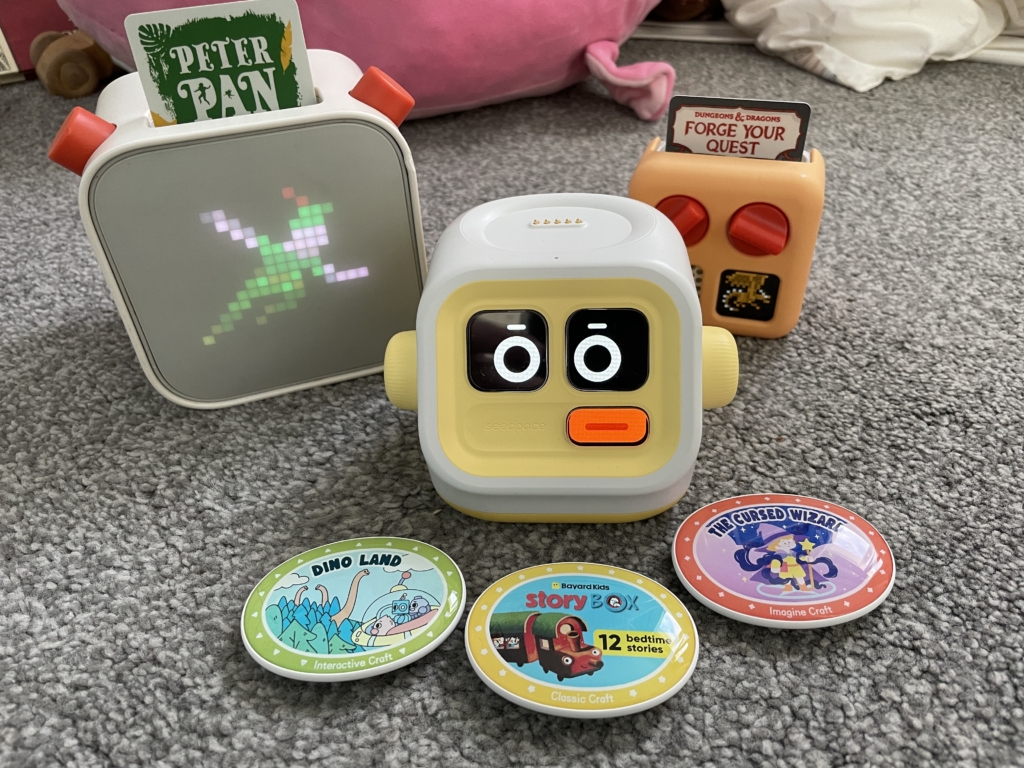 Yoto Player 3rd Gen (left) and Yoto Mini (right) with Seedpace Interactive Player centre. Brilliant gifts for podcast lover's kids. 